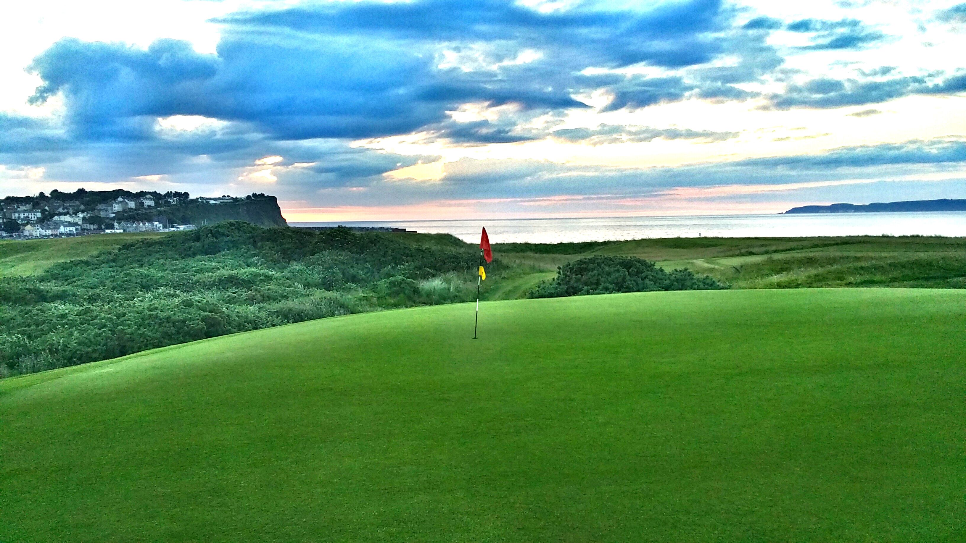 Red flag over hole on golf course